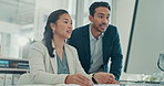Office, woman and discussion with man, computer and pointing at financial report on website or info. Reading, online and people with tech for budget analysis, typing and accountant with project
