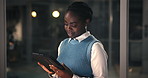 Night, business and black woman with tablet in office, reading feedback or edit investment proposal. Overtime, change budget or employee with tech in workplace, research or review for finance project