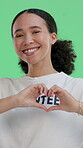 Face, happy woman or volunteer in studio with heart hands for NGO support, wellness or nonprofit service. Person, smile and love for charity, community transformation or refugee care on green screen.