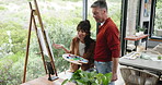 Talking, painting and couple with canvas for hobby, creative project and bonding with artwork in home. Marriage, love and man with woman by window for drawing, artistic creation or picture with easel