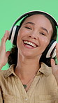 Headphones, dancing and face of woman in studio listening to music, radio or playlist with energy. Happy, audio tech and portrait of female person streaming album or song by green background.