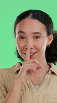 Hush, smile and face of woman on green screen for announcement, privacy and silence. Gossip, private information and rumor with portrait of person on studio background for emoji, mute and news