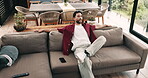 Phone, relax and man stretching on couch for decision, free time choice or weekend break entertainment. Scroll social media, watch movie or person rest in home with options, thinking or contemplating