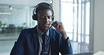Laptop, man and talking with headset in call center for online advice, account management and help. Customer service agent, black person and speaking to client for inbound query, assistance and CRM