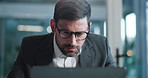 Laptop, glasses and businessman in office with research for finance report with company budget. Computer, reading and financial manager working on investment proposal with stock market in workplace.
