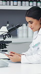 Microscope, science and tablet with woman in laboratory for medical development or research. App, pharmaceuticals and test result with scientist at work on clinical trial for experimental discovery