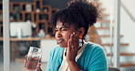 Woman, drinking water and toothache in office at startup with stress, cavity or sore with gum disease. Person, writer and pain with sensitive teeth, massage and glass with project at creative agency