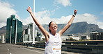 Celebrate, running and woman in city for marathon with achievement, finish and workout goals. Happy, excited and person in town with arms raised for exercise milestone, training and success for race