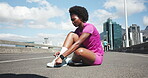 Athlete, woman and tie shoes in city for getting ready, fitness preparation and exercise. Female person, lace footwear or check watch for sports training, runner safety and time of marathon practice 