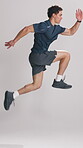 Personal trainer, man and jump in studio for workout video, exercise demonstration or energy performance. Fitness influencer, active and coach with challenge for tutorial, white background and cardio