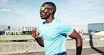 Fitness, running and black man in city for exercise, workout and training for endurance marathon. Cardio, runner and person jog for practice on bridge outdoor for body health, wellness or challenge