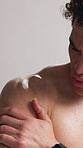 Shoulder pain, fitness and man in studio massage for exercise injury, mistake and workout accident. Sports, white background and person with inflammation, muscle strain and pressure for wellness