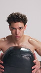 Man, squat and face for exercise with medicine ball, legs and muscle development on white background. Person, weightlifting and bodybuilder in studio, equipment and shirtless for workout in Colombia