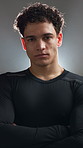 Face, athlete and man with arms crossed in studio for fitness, personal trainer and exercise support. Portrait, person and bodybuilder for coaching pride, sports training and goals on gray background