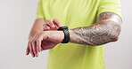 Fitness, hands or man with smart watch in studio to monitor workout, track performance or results. Athlete, person or check timer on white background for health stats, exercise progress or heart rate