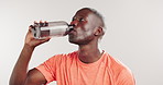Fitness, water and black man in studio for hydration, wellness and health for workout. White background, mockup space and person with bottle, liquid and minerals for exercise, rest and recovery