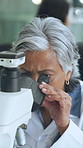 Mature woman, microscope and scientist with analysis for evidence, study and development. Science, microbiology equipment and person in laboratory for medical biotechnology, forensic research or test