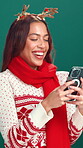 Studio, happy and woman with smartphone, Christmas and planning for festive season with social media. Green background, search and person with mobile for Xmas inspiration, December and scroll on web
