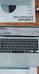 Computer, documents and hands of businessperson in office with report on company finance expenditure. Paperwork, laptop and top view of financial analyst working on investment proposal in workplace.