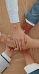 Above, business and people with hand stack on table for teamwork, agreement and partnership. Staff, team huddle and collaboration for solidarity, employees connection and motivation for company goals
