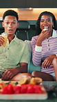 Face, laughing or couple watching tv with snacks on sofa for movie date, funny series or bonding. Gen z, african people or television with drink in home for weekend entertainment, comedy film or love