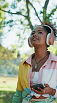 Phone, girl and walking with headphones at park for music playlist, exploring nature and fresh air. Reflection, happy person and stroll with mobile app for streaming podcast and environment scenery