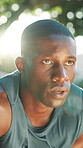 Outdoor, fitness and tired black man on break for workout recovery, cardio and wipe sweat with bokeh. Person, fatigue and runner at park for rest, wellness and breathing for challenge with flare