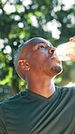 Drinking, water and man in park, fitness and athlete with nutrition on break, hydration and outdoor. Healthy, runner and black person with bottle after exercise, calm and liquid to support digestion