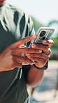 Hands, fitness and man with mobile outdoor for health app, typing text and notification. Phone, exercise and person in nature for online communication,  training schedule and track performance