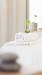 Spa, massage table and towel in hotel for wellness, luxury treatment and peaceful hospitality. Cloth, equipment or bed setup in retreat center for relax, therapeutic bodywork or client stress relief.