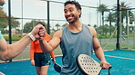 Fist bump, fitness and people with padel on tennis court for practice, match or workout together. Happy, sports and team of athletes with celebration for support in game, training or exercise outdoor