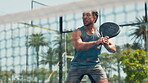 Playing, padel and man with racket, court and training for competition, active and energy for sport. Outdoor, tennis player and person with equipment for game, fitness and celebration for success