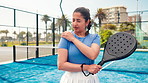 Fitness, padel and woman on tennis court with shoulder pain, injury or accident for match. Sore, sports and female athlete with racket for muscle sprain, torn ligament or inflammation outdoor.