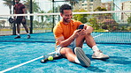 Fitness, texting and man on tennis court with phone, relax and funny post on social media. Laugh, digital or padel athlete outdoor with mobile, wellness chat or virtual tutorial on training break.