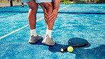 Back, leg pain and padel court with man, inflammation and joint injury with muscle tension. Closeup, outdoor and person with training, medical crisis and accident with fitness, sore and bruise