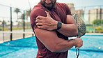 Fitness, padel and man on tennis court with shoulder pain, injury or accident for match. Sore, sports and male athlete with racket for arm muscle sprain, torn ligament or inflammation outdoor.