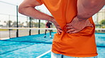 Hands, back pain and man on padel court with injury, medical crisis and accident outdoors. Fitness, health and person with ache, strain and hurt from training, workout and exercise for tennis game