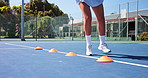 Fitness cones, feet and woman with agility practice on tennis court for balance, coordination or health. Athlete, running and footwork drills for sports endurance, tournament exercise or game control