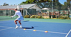 Court, tennis player and woman with racket, energy and training for match with fitness and wellness. Outdoor, athlete and person with equipment for sport, active and preparing for tournament or game
