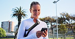 Tennis, sports and woman with phone on court for social media, typing message and fitness app. Outdoor, athlete and happy person on smartphone for connection after workout, exercise and practice