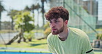 Man, playing and fitness with padel tennis for serve ball, smash or sport training on court. Active, male person or player ready with bat or determination for game, outdoor match or practice on turf