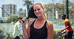 Happy, fitness and face of woman with padel on tennis court for match, training or workout. Smile, cardio and portrait of female athlete with racket for game, practice or exercise outdoor for sports.