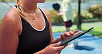 Hands, padel and tablet with person on court for fitness schedule, online booking or planning. Agenda, app and scrolling with sports athlete outdoor at venue for exercise routine or workout time slot