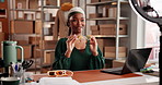 Girl, unboxing and ring light with sunglasses, happy and talk with review for online audience. African woman, dropshipping and influencer with content creation, fashion or social media post at store