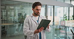 Tablet, doctor and man in hospital for healthcare, review report or patient history. Technology, reading and serious medical worker with telehealth, insurance records and check schedule in clinic
