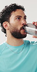 Man, fitness or drinking with water in studio for hydration, rest or break on a white background. Active, male person or thirsty model with mineral liquid or aqua beverage for workout recovery