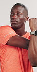 Runner, stretching and arm with black man in studio for health, fitness and muscle. Cardio challenge, sports athlete and training with person on white background for wellness, warm up and workout