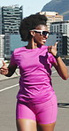 Fitness, running and happy woman with thumbs up on bridge, outdoor training and marathon practice. Exercise, sunglasses and athlete with people for road challenge, resilience and speed development