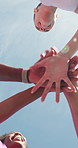 Group, hands stack and low angle for fitness, outdoor and sky with celebration for training goals. Runner, men and women with friends, happy or applause with exercise club for wellness in summer