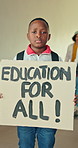 Donation poster, education and face of child student at school for demonstration or protest. Cardboard sign, change and petition with serious boy learner in hallway for knowledge, learning or study
